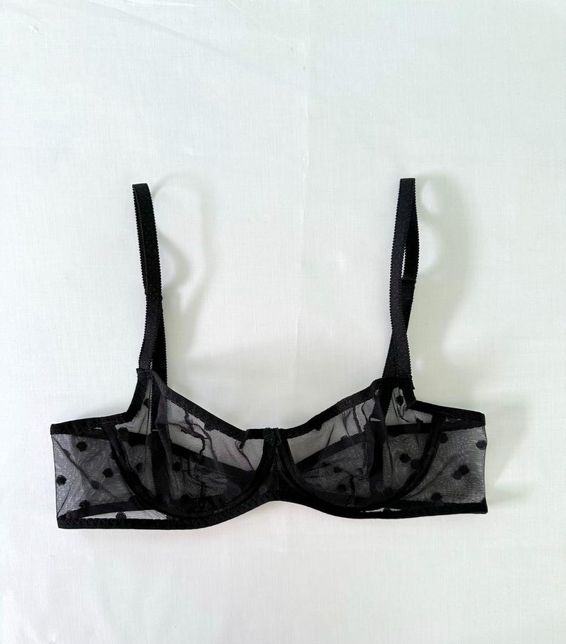 May include: Black polka dot mesh lingerie bra with adjustable straps.