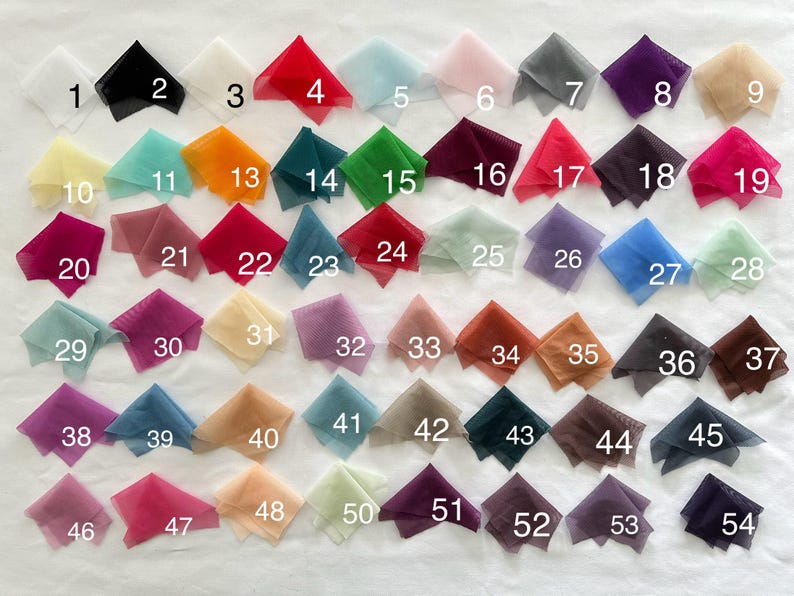 May include: A collection of 54 fabric swatches in various colors and textures. The swatches are numbered 1 through 54.