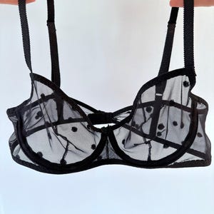 May include: Black polka dot mesh bra with adjustable straps.