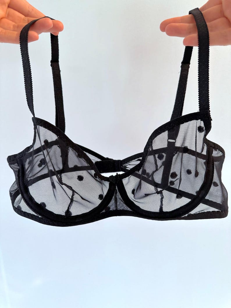 May include: Black polka dot mesh bra with adjustable straps.