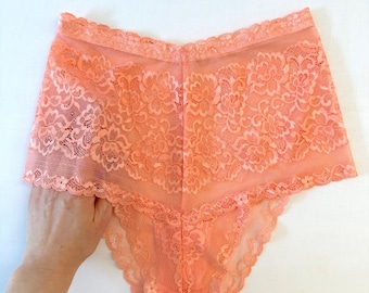 Lace panty on medium waist in soft coral color.