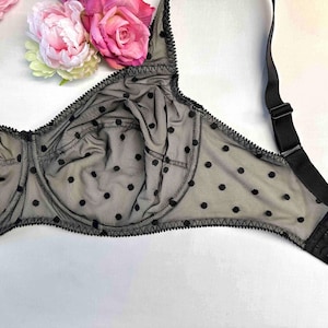 May include: Black polka dot bra with adjustable straps and a delicate lace trim.