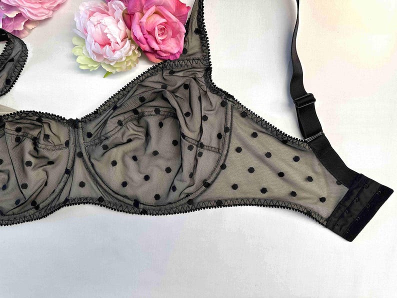 May include: Black polka dot bra with adjustable straps and a delicate lace trim.