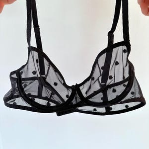 May include: Black polka dot mesh bra with adjustable straps.