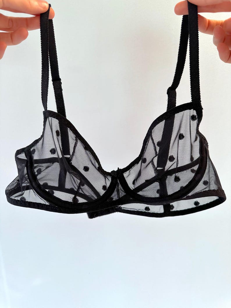 May include: Black polka dot mesh bra with adjustable straps.
