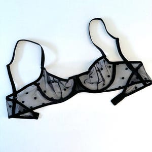 May include: Black polka dot mesh bra with adjustable straps.