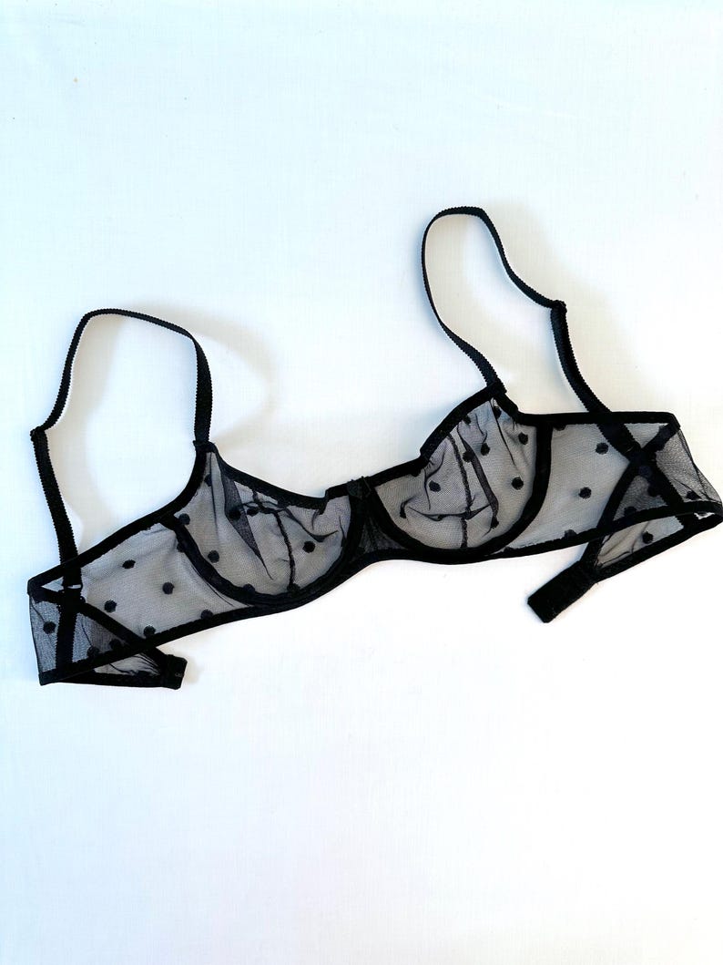 May include: Black polka dot mesh bra with adjustable straps.
