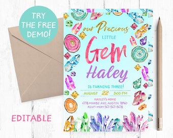 May include: A light blue birthday invitation with watercolor gem illustrations. The invitation reads "Our Precious Little Gem Haley is Turning Three!" with event details. Includes a tan envelope and a pencil.