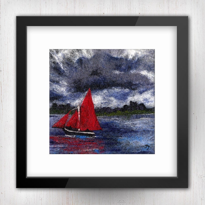 May include: A framed needle felted artwork depicting a red sailboat on a dark blue body of water with a stormy sky above. The artwork is signed "FJ" in the bottom right corner.