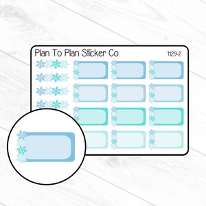 May include: A sheet of blue and turquoise snowflake themed planner stickers with the text "Plan To Plan Sticker Co." and "1129-2".