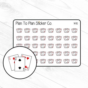 May include: A sheet of 72 white playing card stickers with red and black suits. The stickers are arranged in a grid pattern. The sheet is labelled "Plan To Plan Sticker Co." and "1410".
