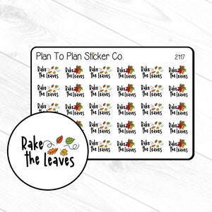 May include: A sheet of stickers featuring the text "Rake the Leaves" and a graphic of autumn leaves. The stickers are white with black text and a colourful leaf design. The sheet is labelled "Plan To Plan Sticker Co." and "2117".