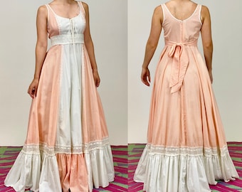 May include: A long, flowy dress with a pink and white gingham pattern. The dress has a white lace trim and a white bodice with a lace-up detail. The dress is sleeveless and has a fitted bodice.