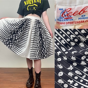 May include: A white and black skirt with a geometric pattern. The skirt is a-line and has a waistband. The skirt is made by the company "Lee of Miami" and has the words "Miami Sportswear Co." on the label.