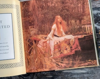 May include: Open book with a full-page illustration of a woman with long red hair in a white dress, seated in a boat on a lake. The artwork has a classical painting style with warm, earthy tones. The book is open on a wooden surface.