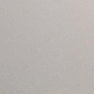 May include: A close-up of a light gray textured surface with a subtle pattern of small white flowers.