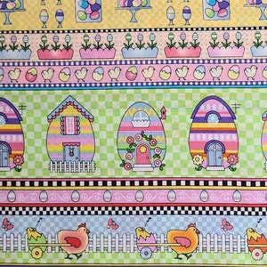 May include: A colorful fabric with a repeating pattern of Easter eggs, houses, and chickens. The fabric features a green and white checkered background with pink, yellow, blue, and purple accents.