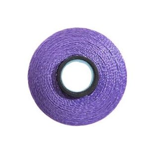 May include: A spool of purple thread.