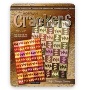 May include: A quilt pattern titled "Crackers" by Hoffman. The cover features two quilt designs, one in warm tones and the other in cool tones. The dimensions are 30" x 48". The design is by Judy Niemeyer Quilting.