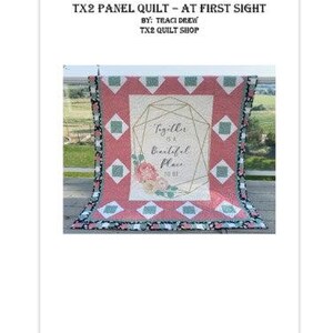 May include: A red and white panel quilt with a geometric design and the text "Together is a beautiful place to be." The quilt has a floral design and is trimmed with a black and white patterned border. The quilt is displayed outdoors.