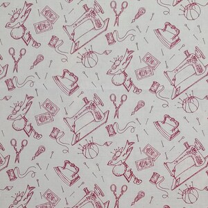 May include: A white fabric with a pink repeating pattern of sewing-themed illustrations. The pattern includes sewing machines, spools of thread, scissors, thimbles, irons, and birds with needles.