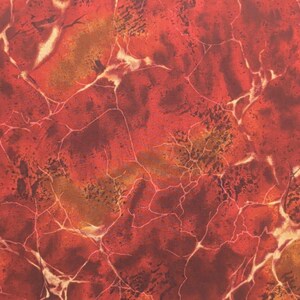 May include: A fabric surface featuring a vibrant red and deep orange marbled pattern. The design consists of dark red splotches and irregular, thin, light-colored vein-like lines that crisscross the entire field, creating a textured appearance.