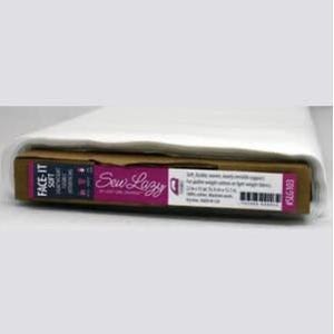 May include: A roll of white fabric, partially unrolled, resting on a cardboard core. The core features the text "FACE-IT SOFT" and "Sew Lazy" in pink and white, along with product information and a barcode. The fabric appears to be lightweight.