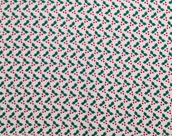 May include: A repeating pattern of green holly leaves and red berries on a white background. The design is evenly spaced and creates a festive, holiday-themed aesthetic. The pattern is suitable for fabric or wrapping paper.