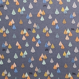May include: A gray fabric with a repeating pattern of colorful triangles, resembling stylized trees. Small black bear silhouettes are scattered throughout the design.