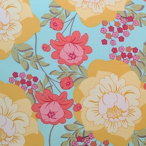 May include: A floral pattern featuring large yellow flowers with white centers, coral and pink blossoms, and small red and pink clusters on a light blue background. Green leaves and stems intertwine throughout the design.