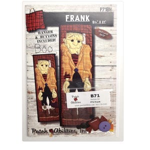 May include: A packaged craft kit featuring a Frankenstein's monster design. The kit includes fabric pieces to create a wall hanging that measures 8.5" x 21". The text "FRANK" and "Boo" are visible.