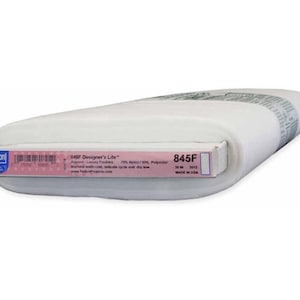 May include: A roll of white fabric labeled "845F Designer's Lite" with a pink and white label. The label indicates the fabric is 70% Nylon and 30% Polyester, and is 30 inches wide. Made in the USA.
