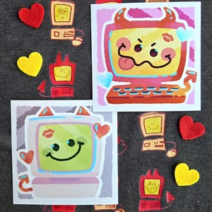 May include: A collection of stickers and felt shapes on a gray background. The stickers feature cartoon computers with devil horns and smiling faces. Red and yellow felt hearts are scattered around the stickers. The computers have keyboards and mice.