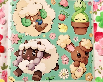 Könnte beinhalten: Ein Set mit fünf Aufklebern mit Pokémon-Charakteren. Die Aufkleber befinden sich auf einem grünen Hintergrund mit rosa und weißen Blumen. Die Charaktere umfassen ein braunes und weißes Schaf, ein weißes Schaf mit einem grünen Wirbel, ein braunes Kaninchen mit weißem Fell und eine grüne Pflanze in einem braunen Topf.