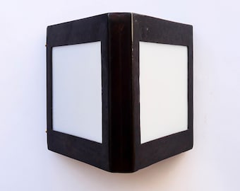 Triangular patinated double-sided wall light