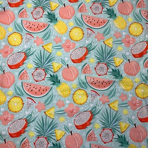 May include: A fabric pattern featuring a repeating design of tropical fruits, including watermelon, dragon fruit, peaches, and pineapples. The fruits are in shades of pink, yellow, and orange, set against a light blue background with green leaves and pink flowers.