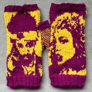 May include: A pair of knitted fingerless gloves in yellow and purple. The gloves feature a portrait design on the back of the hand. The wrist cuffs and the portrait outlines are purple, while the rest of the gloves are yellow.