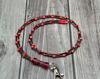 Maud - Black rainbow lanyard with red accents & red focal piece.