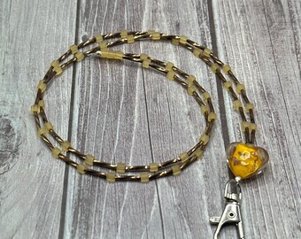 Dolores - Brown lanyard with yellow accents & yellow heart focal piece.