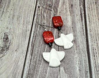 Tatiana Coral with white bird fetish earrings