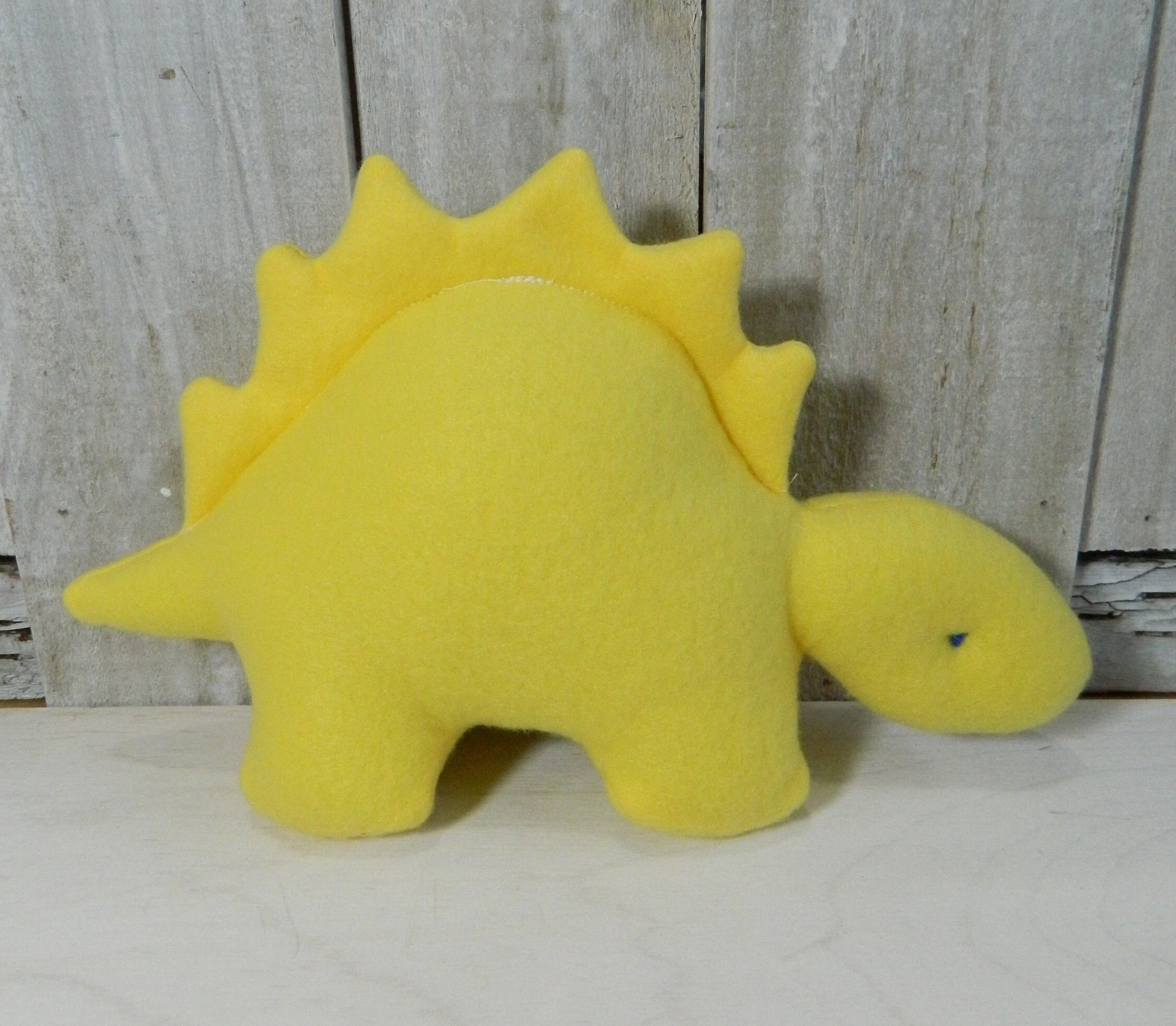 yellow stuffed dinosaur