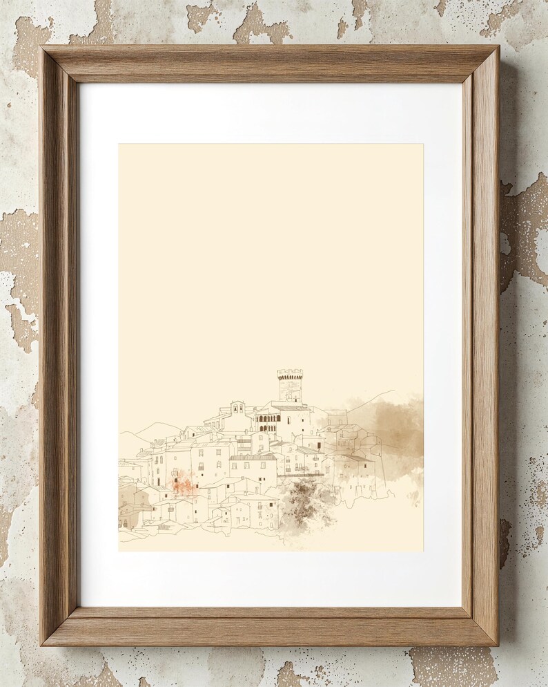 May include: A framed wall art print featuring a fine-line ink drawing of a hillside village with a central tower. The artwork is set against a pale cream background with soft, muted brown watercolor-style washes and is encased in a light wood frame.