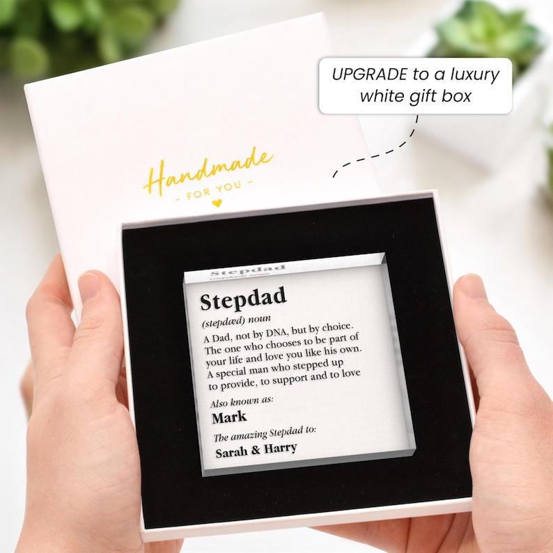 May include: A white gift box with a black interior holds a clear acrylic block. The block features the definition of "Stepdad" and the names "Mark", "Sarah & Harry". The box is labeled "Handmade - FOR YOU" in gold lettering.