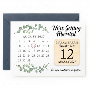 May include: A wedding save-the-date card with a calendar design. The card features the text "We're Getting Married" and "Save the date 12 August 2027". The card is decorated with green botanical elements and comes with a navy blue envelope.