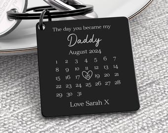 May include: Black metal keychain with the text "The day you became my Daddy August 2024" and a calendar with the 18th circled. The text "Love Sarah X" is at the bottom.