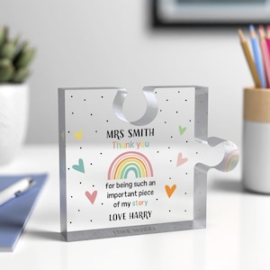 May include: Transparent acrylic puzzle piece with the text "MRS SMITH Thank you" above a rainbow graphic. Below the rainbow, the text reads "for being such an important piece of my story LOVE HARRY". It features colourful heart and dot accents.