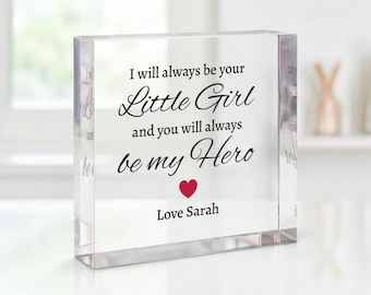 May include: A clear acrylic block with the text "I will always be your Little Girl and you will always be my Hero. Love Sarah." A red heart is below the text. The block is a sentimental gift.
