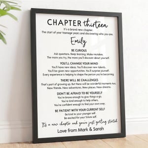 May include: A black framed wall art print featuring a white background with black text titled CHAPTER thirteen. The text includes personalised advice for a teenager named Emily, ending with the message It's a new chapter and you're just getting started, signed by Mark & Sarah.
