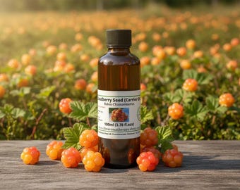 May include: A brown glass bottle with a black cap, labeled "Cloudberry Seed (Carrier Oil)" and a picture of cloudberries. The bottle is surrounded by orange cloudberries and green leaves, with a field of cloudberries in the background. The bottle contains 3.78 fl. oz.