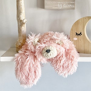 Pink Plush Bear sitting on a wall shelf next to a moon and cloud